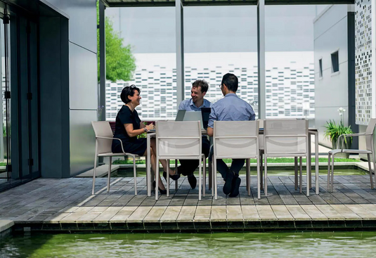 Fermob Calvi outdoor rectangular dining table, 195x95 cm, with eight seats, suitable for outdoor and indoor use.