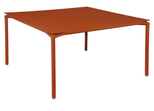 Fermob CALVI square dining table in candied orange finish, 140x140 cm, suitable for eight seats, metal tabletop.