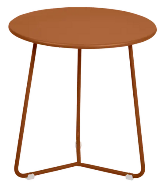 Small Fermob Cocotte occasional table with a candied orange finish, featuring a round top and sleek design.
