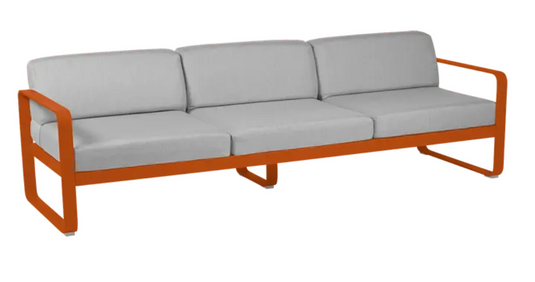 Fermob Bellevie 3-seater outdoor sofa with metal frame, grey cushions, and candied orange fabric for stylish outdoor seating.