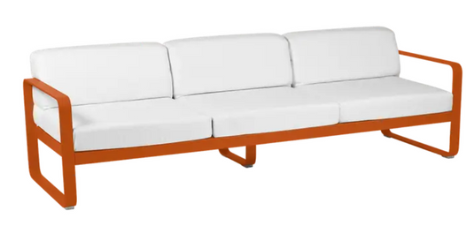 Bellevie 3-seater outdoor sofa by Fermob with white and orange cushions, metal frame, stylish outdoor furniture for patio or garden.