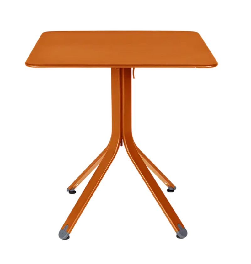 Load image into Gallery viewer, Fermob Rest'O folding outdoor table in metal with 71x71cm square top, shown in candied orange color.
