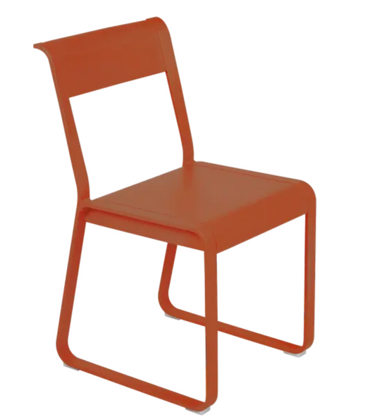 Fermob Bellevie Chair V2 in Candied Orange, a stylish outdoor metal chair with a modern, curved design.