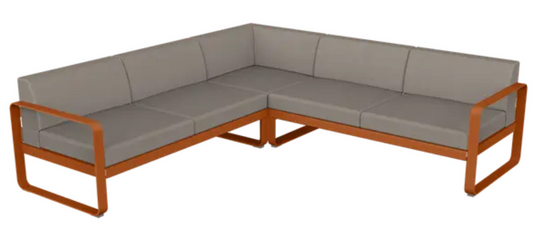 Fermob Bellevie Composition 2 outdoor lounge sofa set with orange, grey, and taupe cushions on a modern patio.