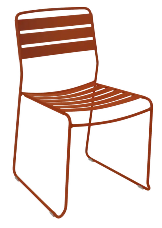 Candied orange Fermob outdoor Surprising Chair with curved metal design, perfect for outdoor dining or patio seating.