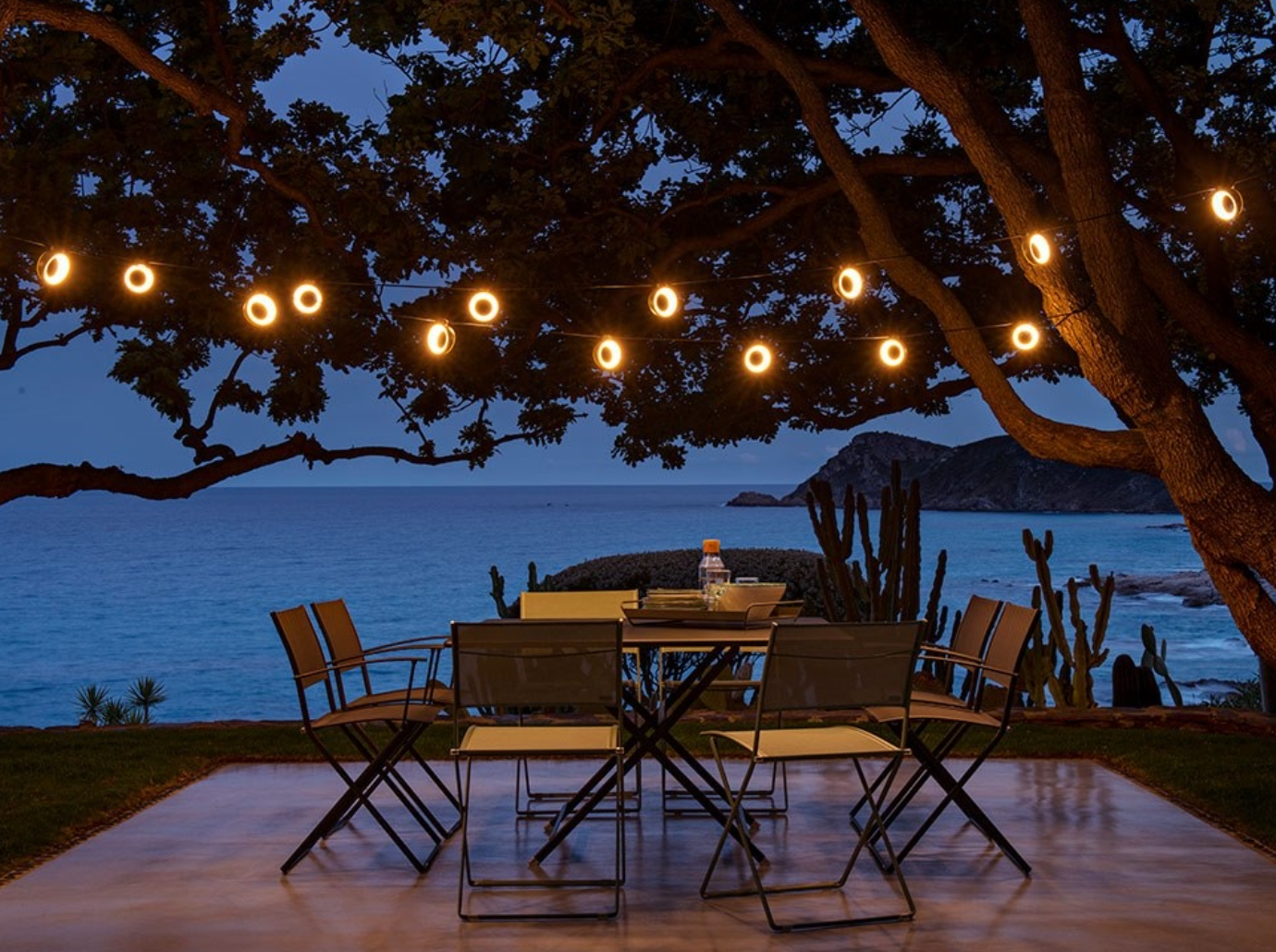 Fermob CARACTÈRE foldable outdoor table in beige, 128x128 cm, eight-seater with a sturdy design and smooth folding mechanism.