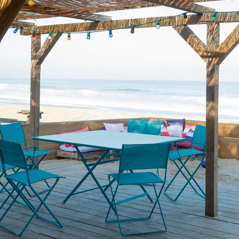 Load image into Gallery viewer, Fermob Caractère foldable outdoor table, 128x128 cm, eight-seater with wooden slats and sturdy metal frame, suitable for outdoor dining.
