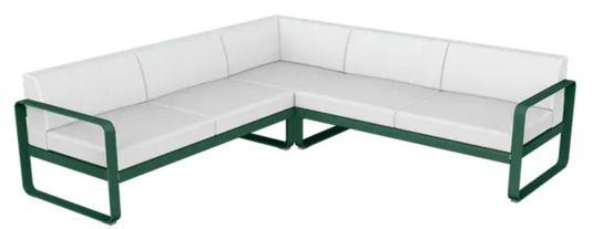 Fermob Bellevie modular outdoor sofa set with cedar, green, and off-white cushions in a stylish garden setting