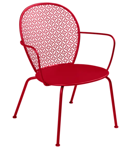 Fermob LORETTE low armchair with a metal frame in vibrant chili red, suitable for outdoor seating.
