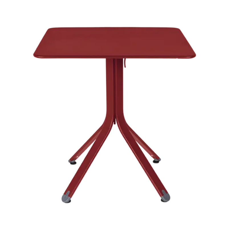 Load image into Gallery viewer, Fermob Rest'O folding outdoor metal table in Chilli Acapulco Blue, 71x71cm, shown folded with a smooth surface and sturdy legs.
