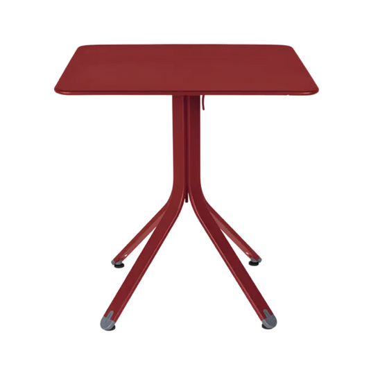 Fermob Rest'O folding outdoor metal table in Chilli Acapulco Blue, 71x71cm, shown folded with a smooth surface and sturdy legs.