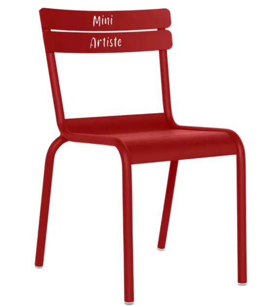 Fermob Luxembourg Kid Chair “Mini Artiste” in vibrant red, designed for children, featuring a sleek wooden frame and playful style.