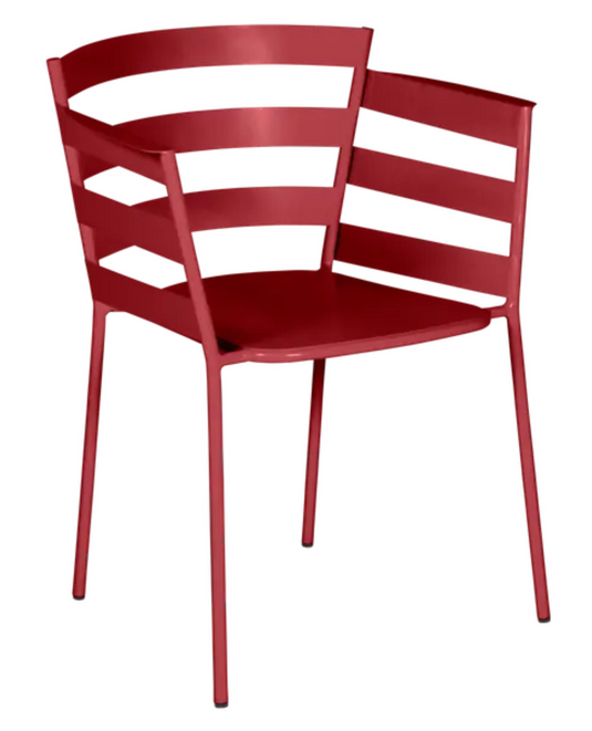 Bright red Fermob RYTHMIC outdoor armchair with a modern design, featuring a curved back and armrests for outdoor relaxation.