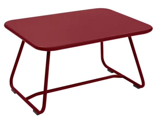 Fermob Sixties low outdoor table in vibrant chili color, 76x55.5cm, suitable for patio or garden seating areas.