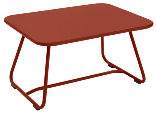 Fermob Sixties low outdoor table measuring 76x55.5cm, with a vibrant chili red finish, suitable for patio or garden use.
