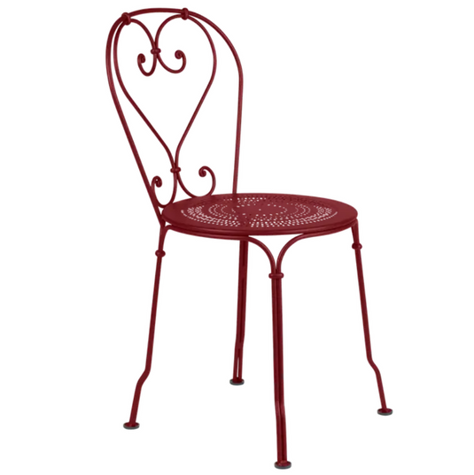 Fermob 1900 outdoor chair in vibrant chili red, with a classic metal design and slatted seat for outdoor patio use.