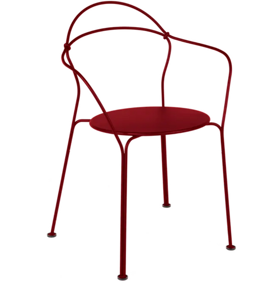 Fermob Airloop lounge chair in vibrant red metal with a modern, curved design for outdoor relaxation.