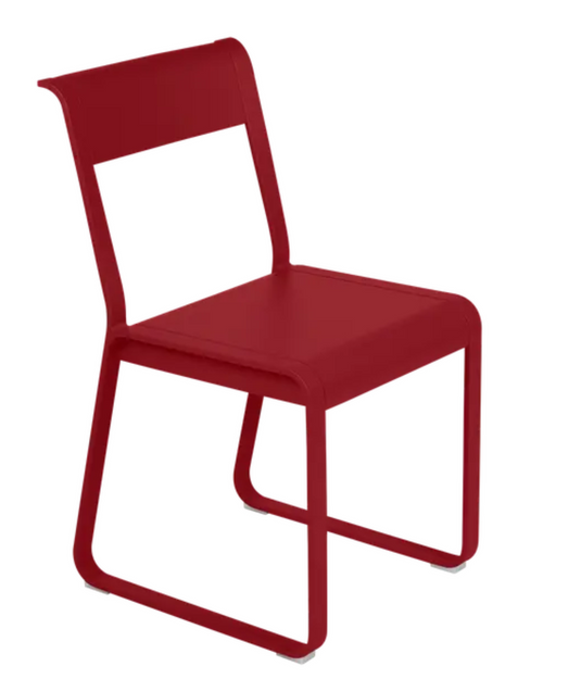 Red Fermob Bellevie Chair V2 metal outdoor chair with sleek design and curved backrest.