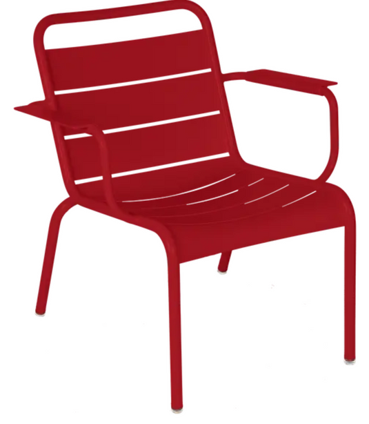 Fermob Luxembourg garden armchair lounge in vibrant chilli color, featuring a stylish outdoor seating design with armrests.