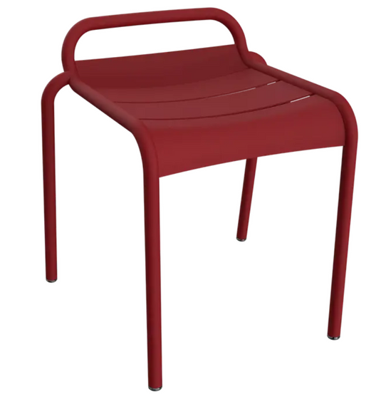 Fermob Luxembourg outdoor dining stool in bright chilli color, made of durable outdoor furniture material.
