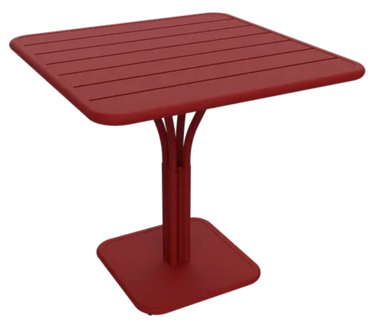 Fermob Luxembourg outdoor pedestal table, 80x80 cm, with a sleek design and vibrant red chili color, suitable for patio or garden.