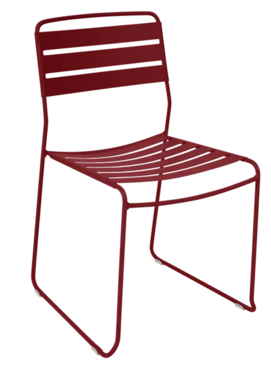 Bright red Fermob Surprising outdoor chair with a sleek modern design, suitable for restaurant or outdoor patio settings.