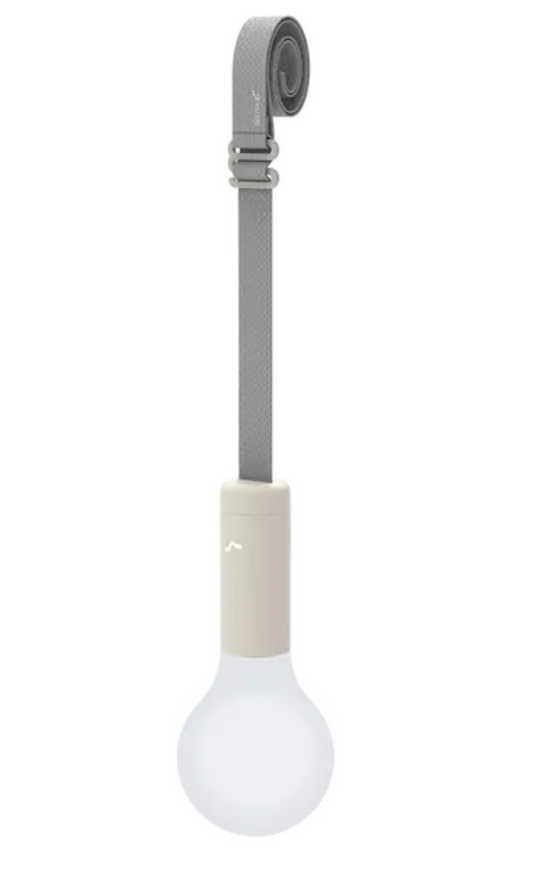 Fermob APLÔ suspended lamp with a clay grey finish hanging from a strap, rechargeable LED lighting for modern interior decor.
