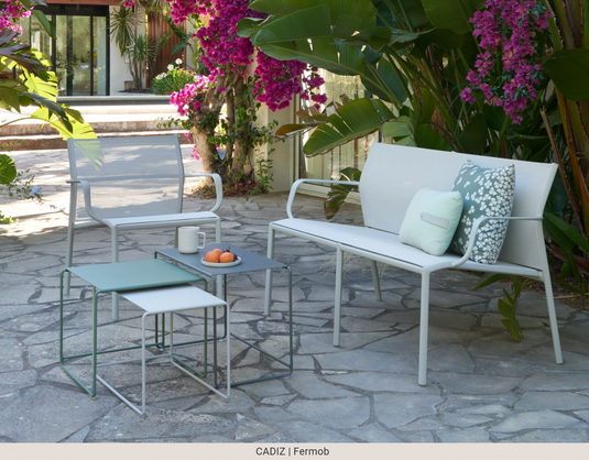 Clay grey Fermob Cadiz 2-seater outdoor aluminum bench with technical fabric seating, suitable for garden or patio use.