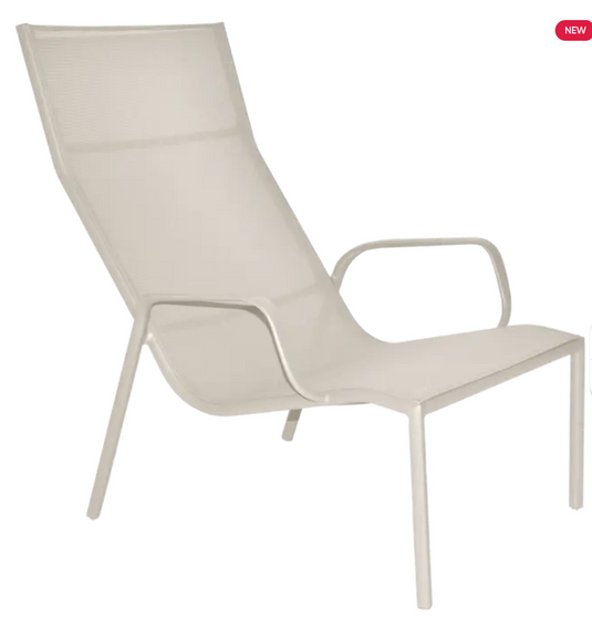 Fermob Cadiz Lounge Armchair in clay grey with a curved design and cushioned seat, suitable for outdoor or indoor lounging.