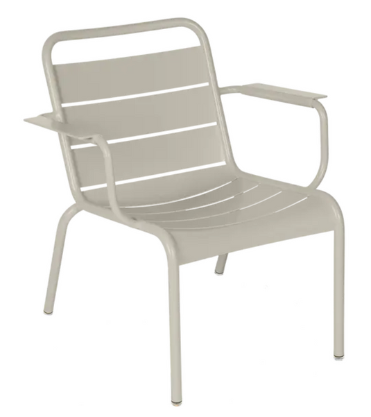 Clay grey Fermob Luxembourg garden armchair lounge with white cushions, stylish outdoor seating for relaxing in the garden.
