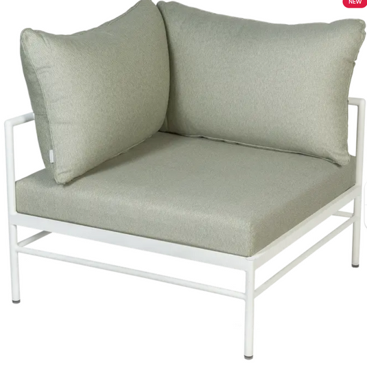 Cotton Meadow Green Fermob Rivage Corner Armchair in a corner outdoor metal sofa setting with plush cushions.