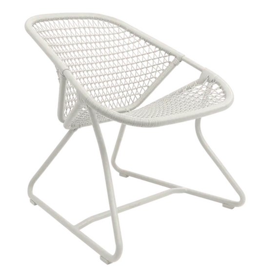 Cotton white Fermob Sixties Low Armchair woven lounge chair with a stylish, minimalist design for modern restaurant seating.