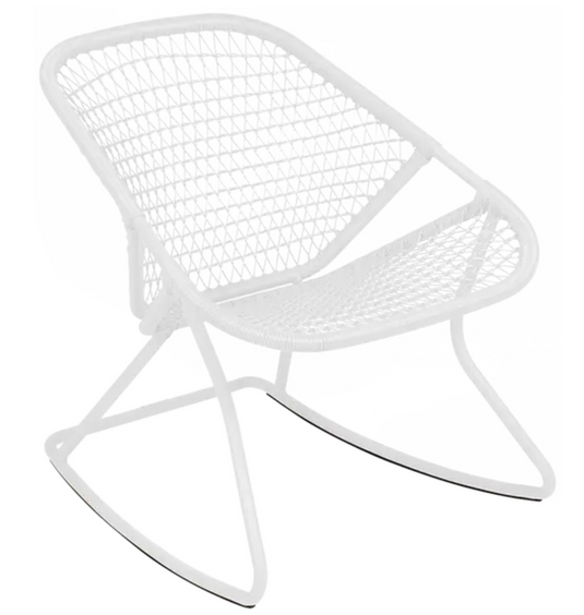 Cotton white Fermob outdoor metal Sixties rocking chair with a curved backrest and armrests on a patio setting.
