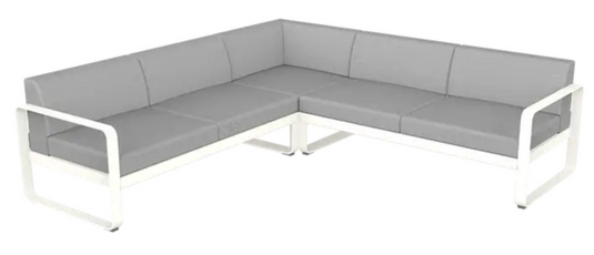 Fermob Bellevie Composition 2 outdoor lounge set with white cotton and grey flannel cushions on a modern sofa.