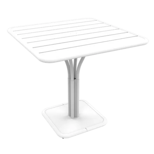 White Fermob Luxembourg outdoor pedestal table, 80x80 cm, with a sleek round design perfect for outdoor patio or garden space.