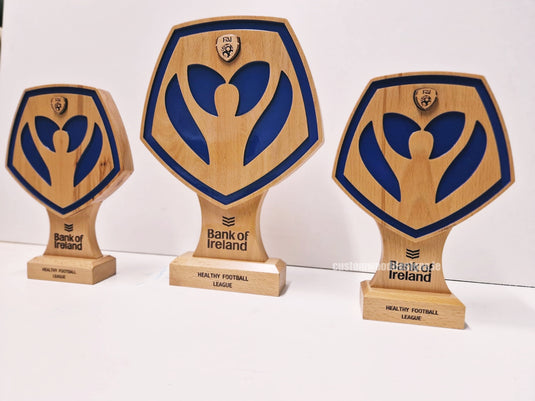 Custom Wood Designs award for the FAI Bank of Ireland Healthy Football Awards featuring engraved shamrock design and a sleek wooden finish.