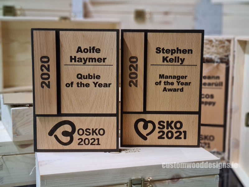 Load image into Gallery viewer, Custom wood awards by Custom Wood Designs featuring carved and laser-engraved company logos on elegant wooden trophies.
