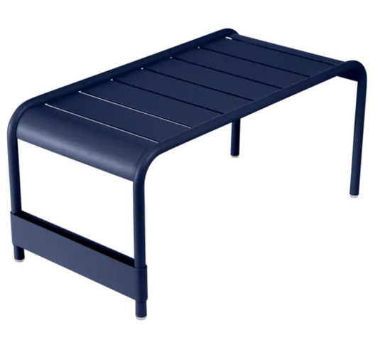 Deep blue Fermob Luxembourg large low table bench measuring 86x44, with a sleek, modern design and smooth wooden surface.