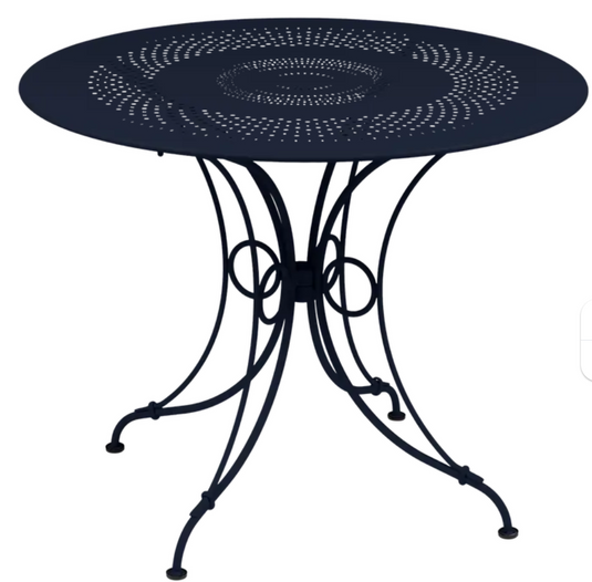 Deep blue Fermob 1900 outdoor table with 96cm diameter, metal design perfect for garden or patio outdoor furniture.