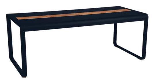 Deep blue Fermob Bellevie outdoor dining table with eight seats, wood and metal construction, featuring built-in storage.