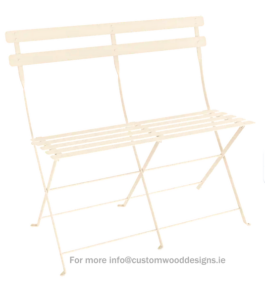 Fermob latte beige two-seater folding ottoman bench with wooden legs, designed for versatile seating and style.