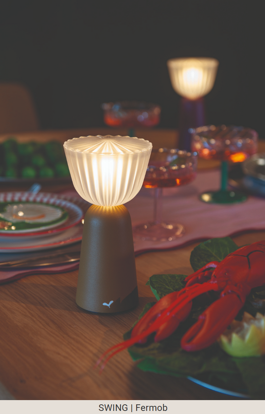 Set of six Fermob Swing rechargeable outdoor lamps with charging tray, stylish modern lighting for outdoor spaces.