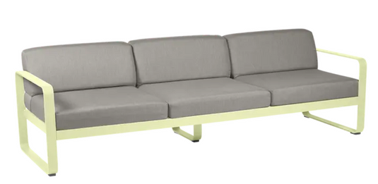 Fermob Bellevie 3-seater outdoor sofa with frosted lemon, grey, and taupe cushions, metal frame, suitable for outdoor patio.