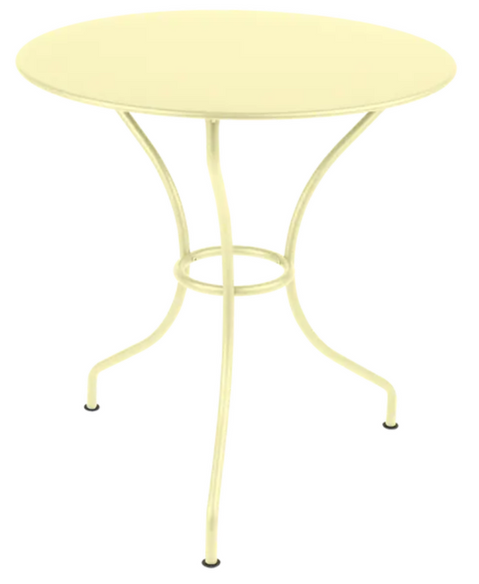 Fermob OPÉRA+ outdoor metal table with a frosted lemon finish, 67 cm diameter, ideal for patio or restaurant outdoor seating.
