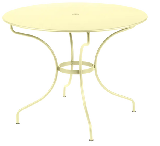 Fermob OPÉRA+ outdoor metal table with a 96 cm diameter, five-seater patio table in frosted lemon finish.