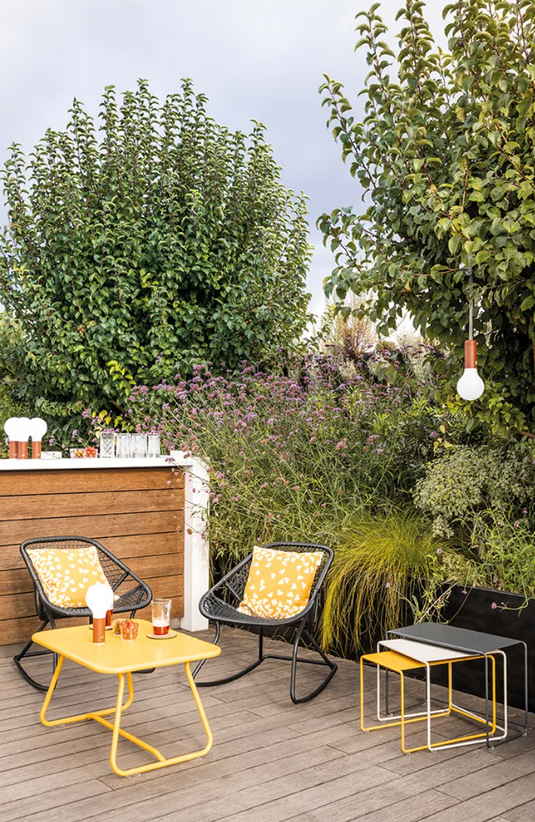 Fermob Sixties low outdoor table in frosted lemon finish, measuring 76 x 55.5cm, suitable for garden or patio use.