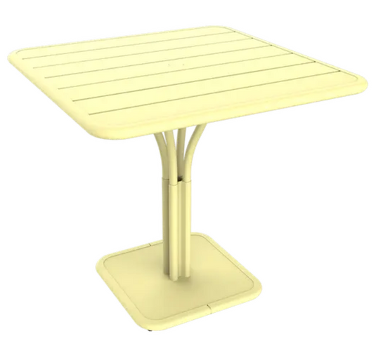 Fermob Luxembourg outdoor pedestal table, 80x80 cm, with frosted lemon white finish, suitable for patio or garden.