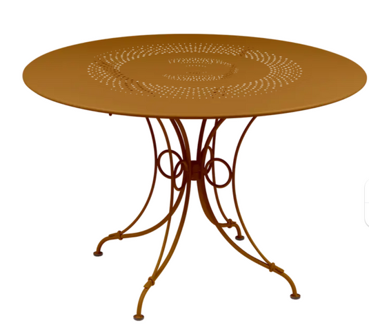 Fermob 1900 outdoor round table with 117 cm diameter in ginger color, suitable for outdoor patio or garden seating.