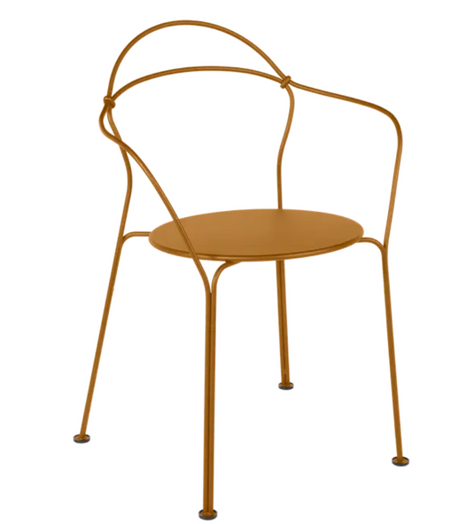 Fermob Airloop lounge chair in gingerbread color, outdoor metal furniture with curved armrests and modern design.