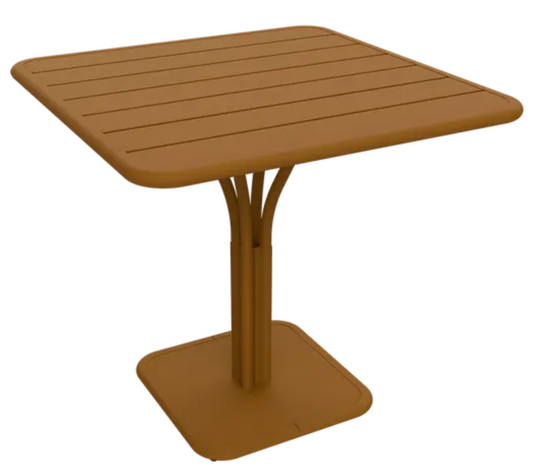 Fermob Luxembourg outdoor pedestal table in gingerbread white with 80x80 cm round tabletop, ideal for patio or garden space.